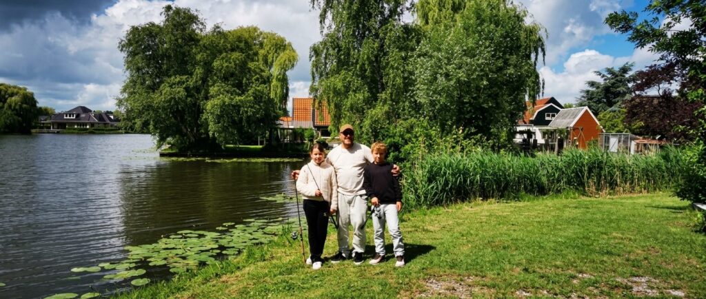 Familie mit Angelruten am Ufer eines Sees in Holland